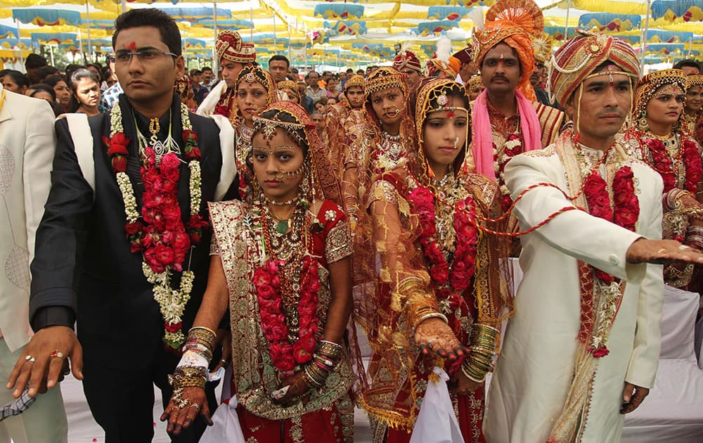 Newly wed couples take a pledge to stop the dowry system during a mass marriage where 31 couples got married in Ahmadabad.