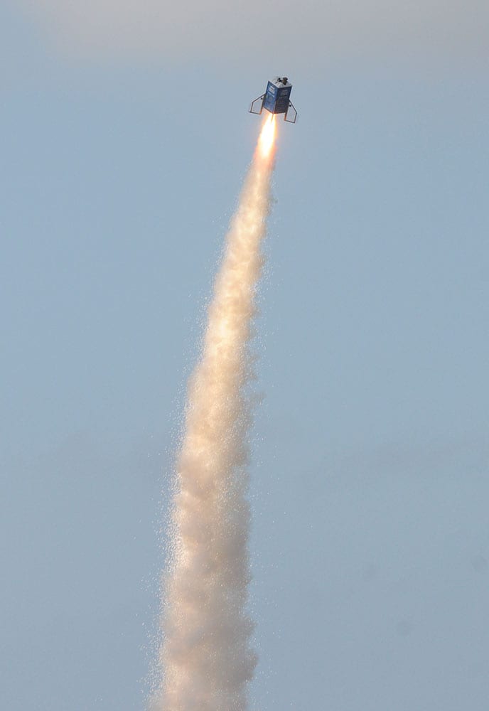 Members of the Michiana Rocketry launch a 10-foot, 450 pound porta-potty, mounted on rocket motors, from a field in Three Oaks, Mich.