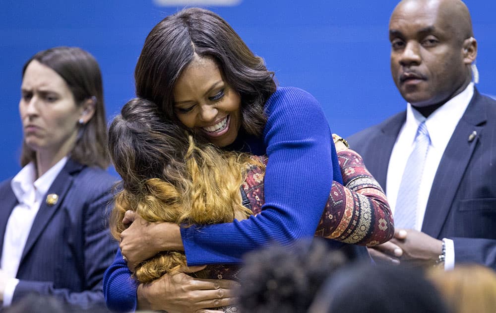 First lady Michelle Obama hugs a Capital City Public Charter School student after speaking at the school in Washington.