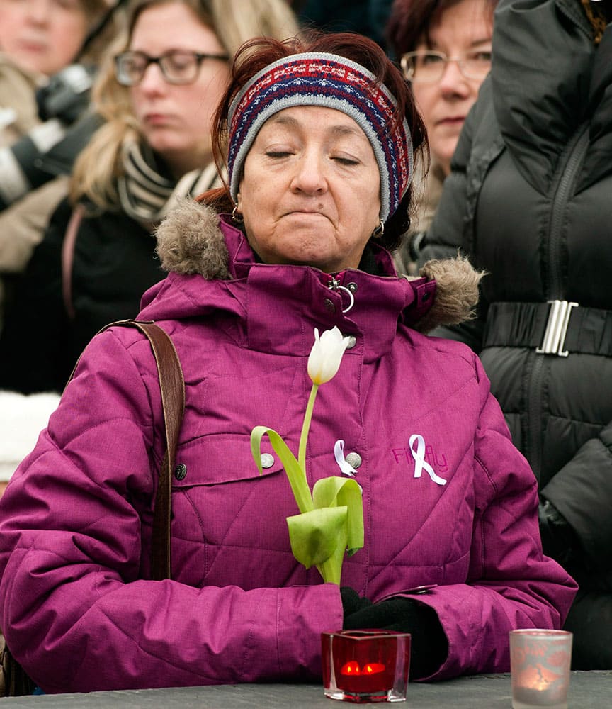 A woman takes part in a ceremony at the memorial park to mark the 25th anniversary of the Polytechnique massacre in Montreal. 