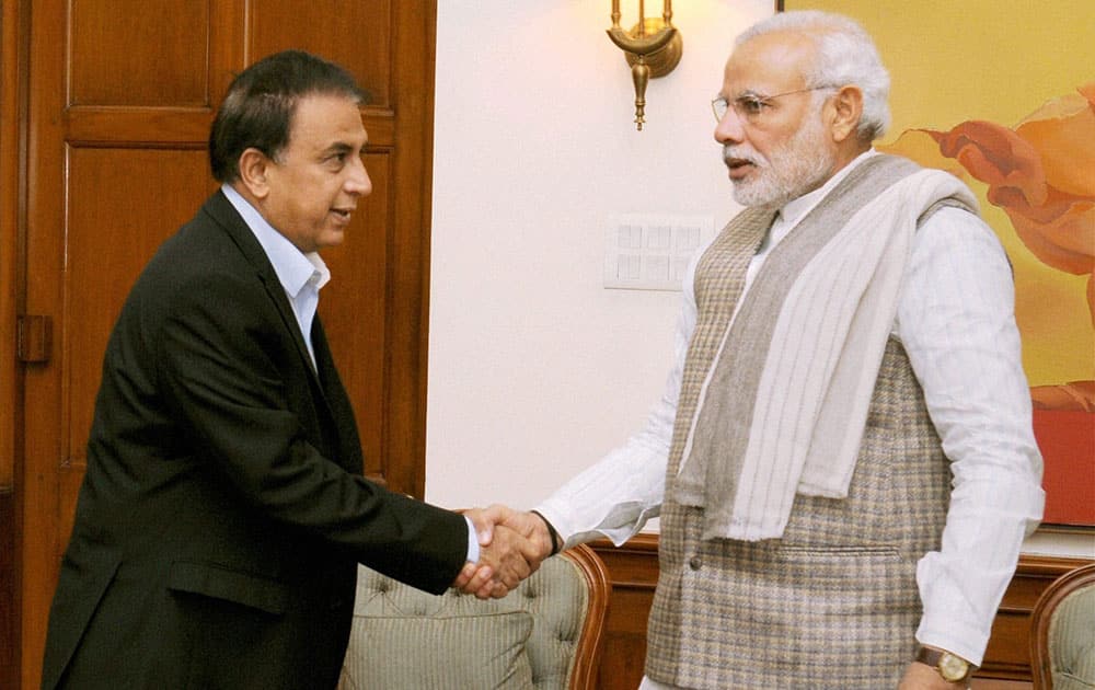 Prime Minister Narendra Modi shakes hand with former cricketer Sunil Gavaskar during their meeting in New Delhi.