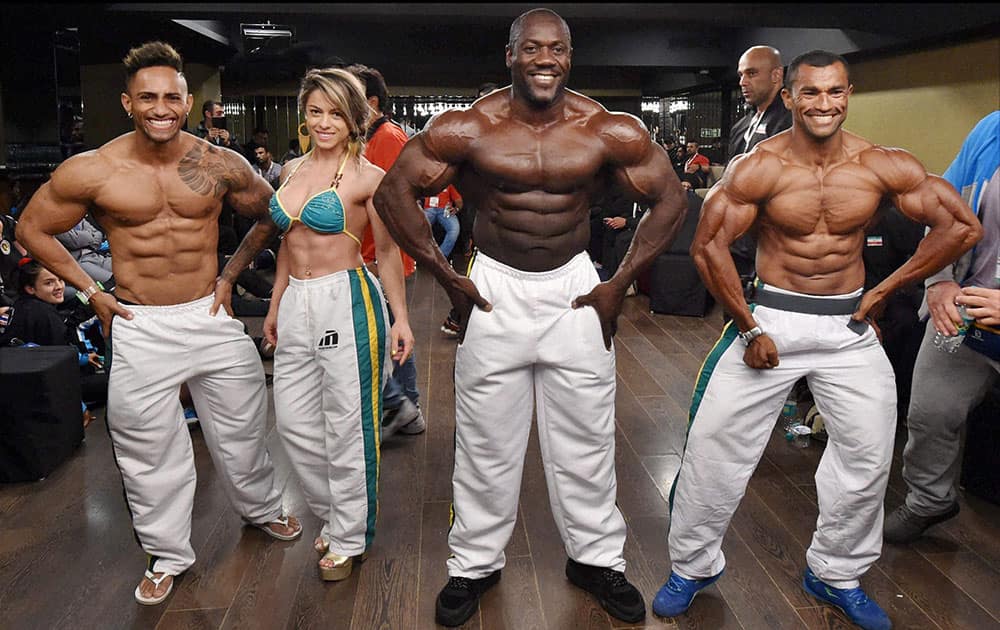 Brazilian bodybuilders pose during the registration of 2014 World Body Building and Physique Sports Competition at the Bombay Exhibition Centre, in Mumbai.