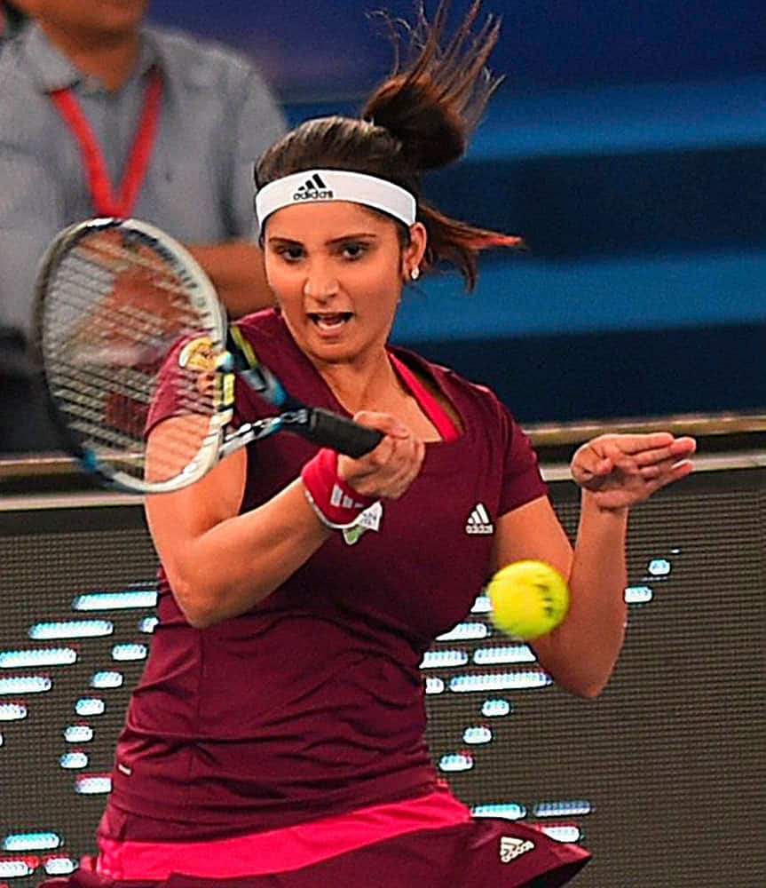 Micromax India Aces, Sania Mirza plays a shot during a mix doubles match against Manila Mavericks players Flipkens and Nester at the International Premier Tennis League (IPTL) at IGI stadium in New Delhi.