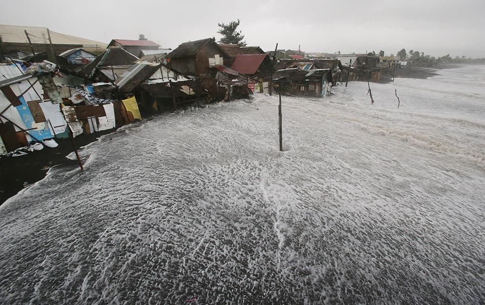 Strong waves crash into coastal houses as Typhoon Hagupit pounds Legazpi, Albay province, eastern Philippines.