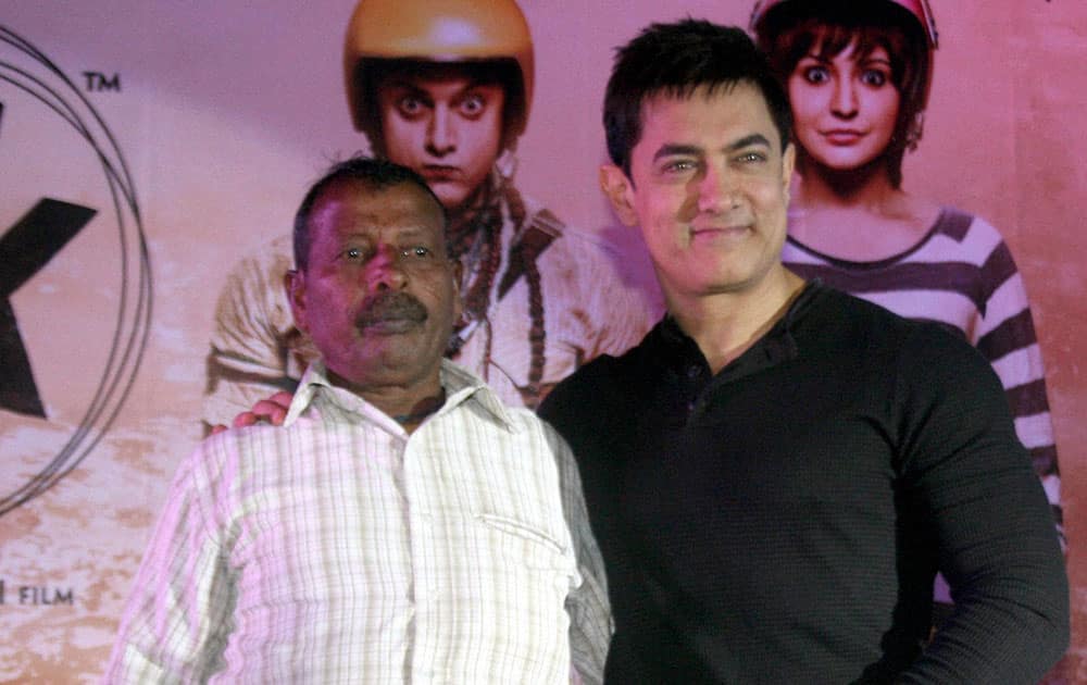 Bollywood actor Amir Khan with his friend Ram Lakhan during the promotional event of his upcoming movie PK in Varanasi.