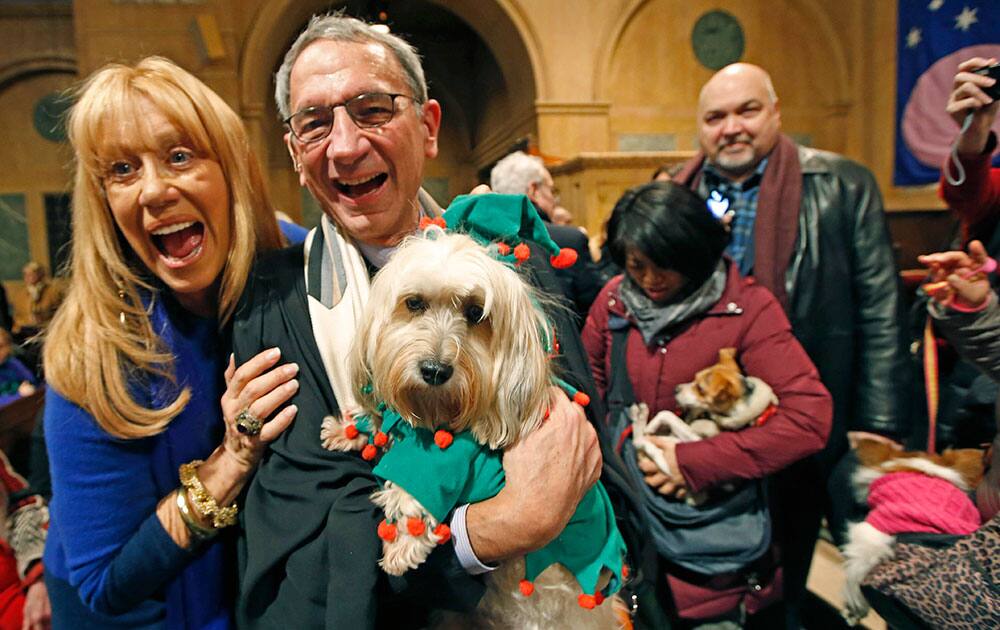 Caroline Lieberman, originally from Australia and currently a resident of New York City, laughs as she poses for a picture her dog Mumbai and Central Synagogue Senior Rabbi Peter J. Rubenstein during the 6th annual Blessing of the Animals at Christ Church of Manhattan in New York.