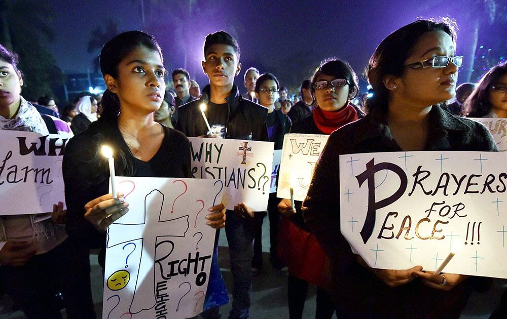 Children from Christian community take part during a candle light vigil against recent fire in a Delhi Church, in New Delhi.