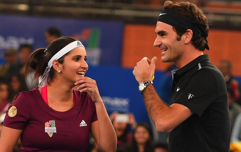 Micromax India Aces, Sania Mirza and Roger Federer during their mix doubles match against Singapore Salmmers at the International Premier Tennis League (IPTL) at IGI stadium in New Delhi.