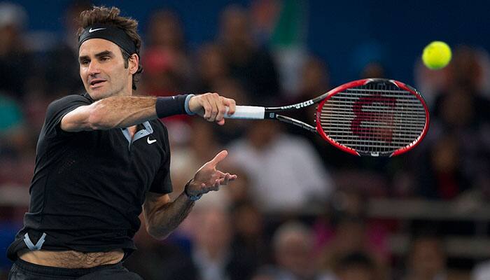 Micromax Indian Aces player Roger Federer returns a shot of DBS Singapore Slammers's Tomas Berdych in the men's singles match, during International Premier Tennis League, in New Delhi.