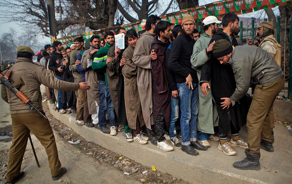 Indian policemen frisk the crowd outside Sheri Kashmir cricket stadium where Prime Minister Narendra Modi will address a campaign rally ahead of the local elections in Srinagar, India.