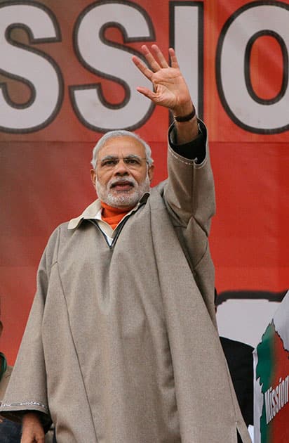 Indian Prime Minister Narendra Modi waves towards his supporters during a campaign rally ahead of local elections in Srinagar, Indian controlled Kashmir.