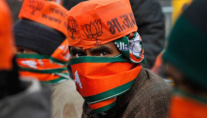 A Kashmiri supporter of Indian Prime Minister Narendra Modi, looks at camera as he and others await Modi's arrival during a campaign rally ahead of local elections in Srinagar.