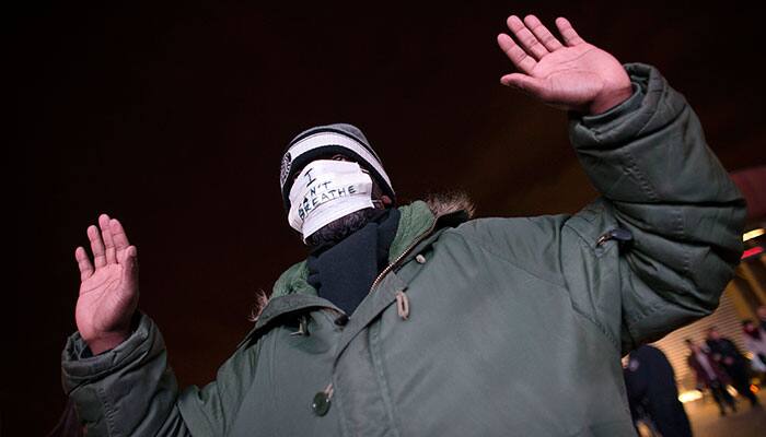 A protestor holds his hands up during a demonstration outside the Barclays Center against a grand jury's decision not to indict the police officer involved in the death of Eric Garner, in the Brooklyn borough of New York.