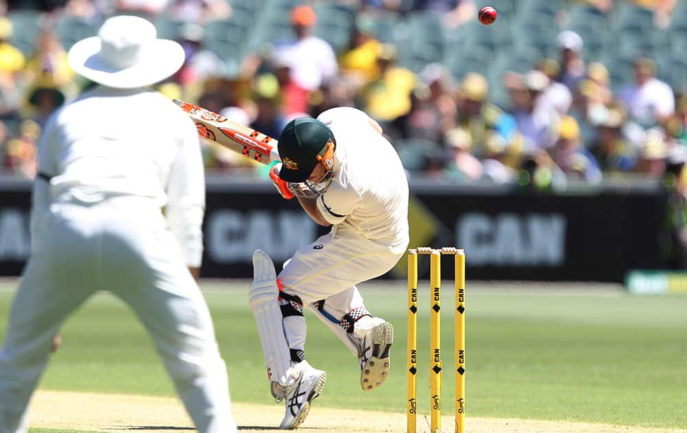 Australia's David Warner ducks a bouncer from India's Varun Aaron during Day 1 of the cricket match in Adelaide. Australia.