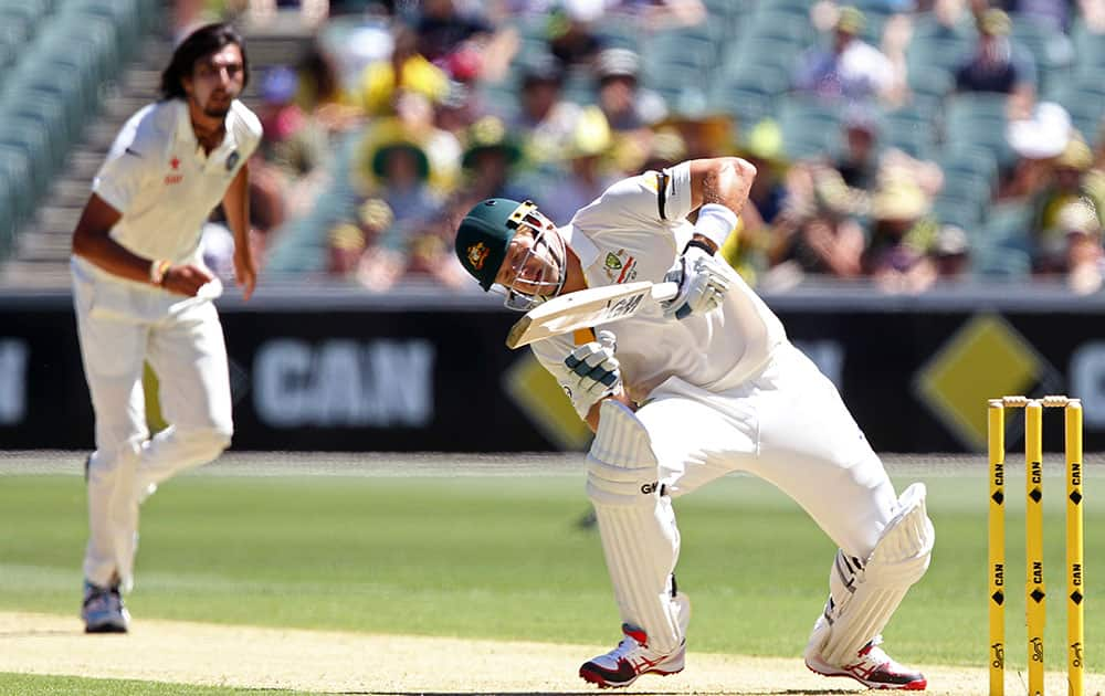 Australia's Shane Watson, right, stumbles following a delivery from India's Ishant Sharma, left, on the first day of a cricket test match in Adelaide, Australia.