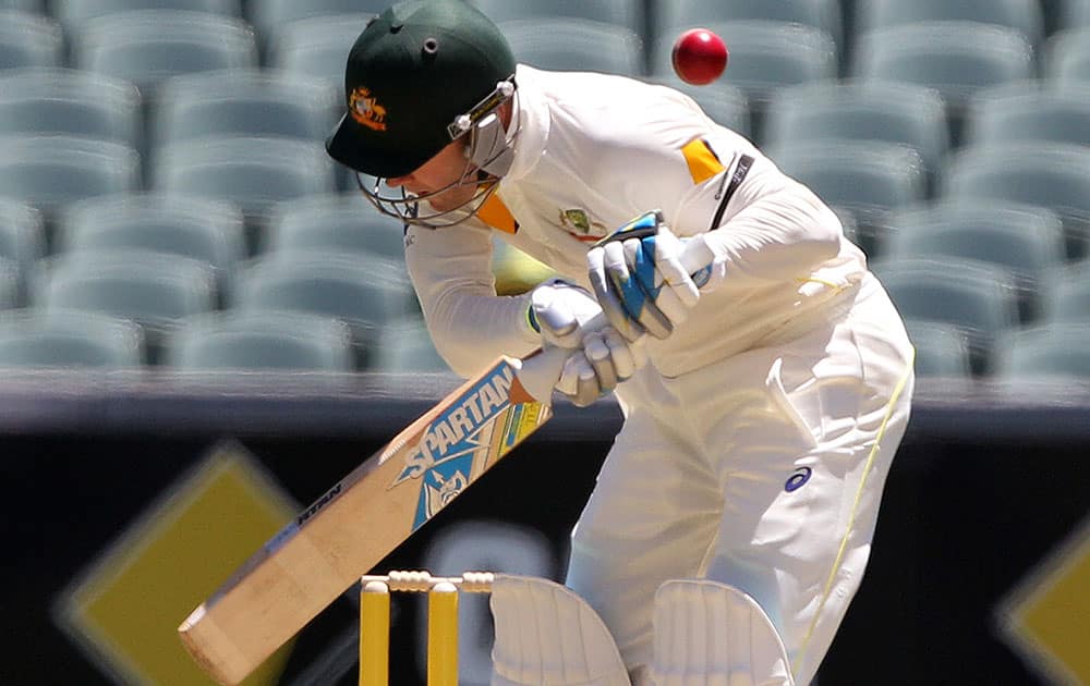 Australia's Michael Clarke has a ball fly over his back during the first day of the cricket match against India in Adelaide, Australia.