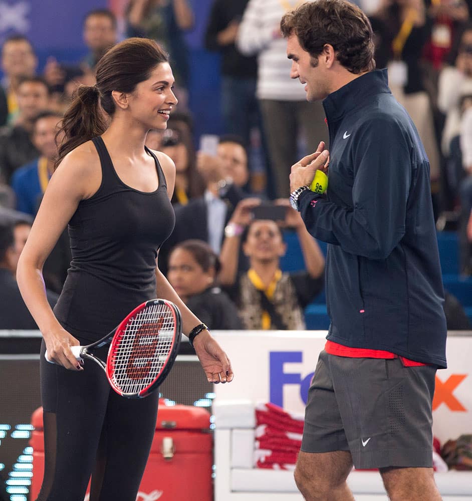 Bollywood actress Deepika Padukone, left, shares a lighter moment with Roger Federer during a fun match in the sidelines of the International Premier Tennis League, in New Delhi.