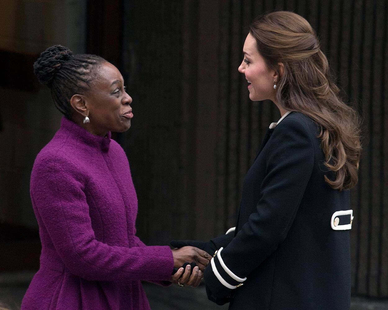 New York City first lady Chirlane McCray, left, and Britain's Kate, Duchess of Cambridge, shake hands outside the Northside Center for Child Development, in New York.