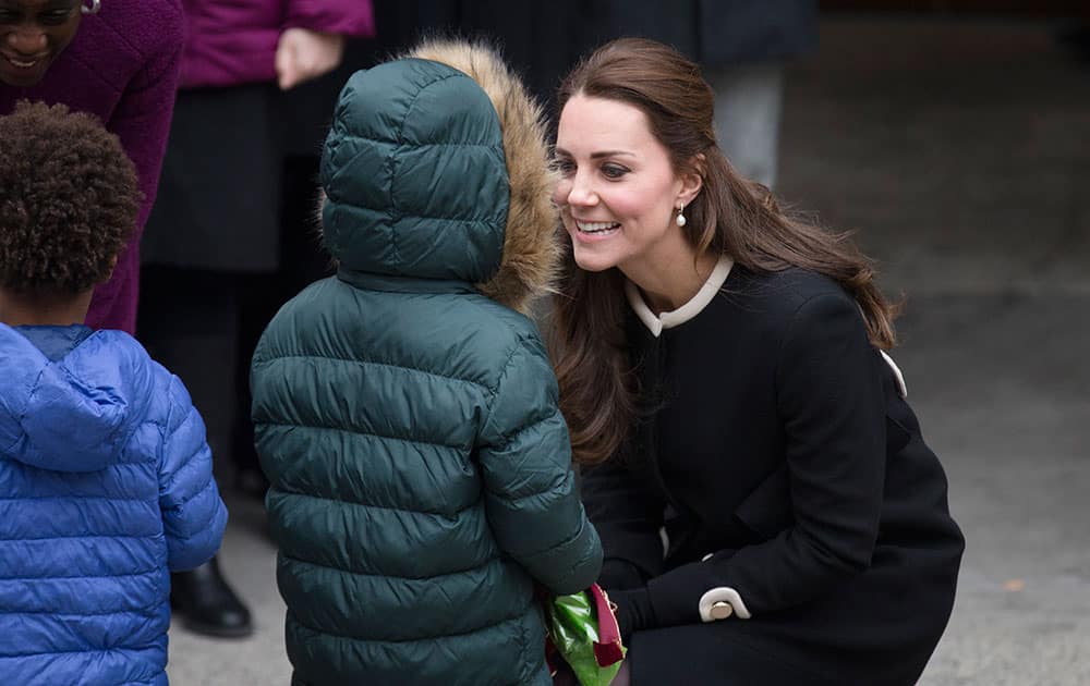 Britain's Kate, Duchess of Cambridge, accept flowers from a student outside Northside Center for Child Development, in New York.