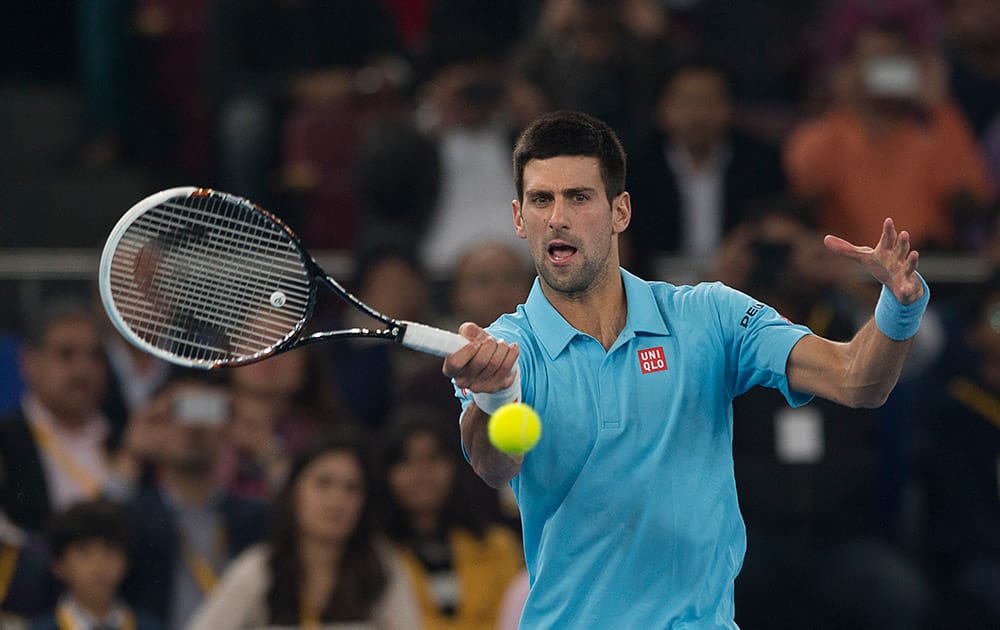 Musafir.com UAE Royals Novak Djokovic returns a ball to Micromax Indian Aces player Roger Federer during the International Premier Tennis League, in New Delhi.