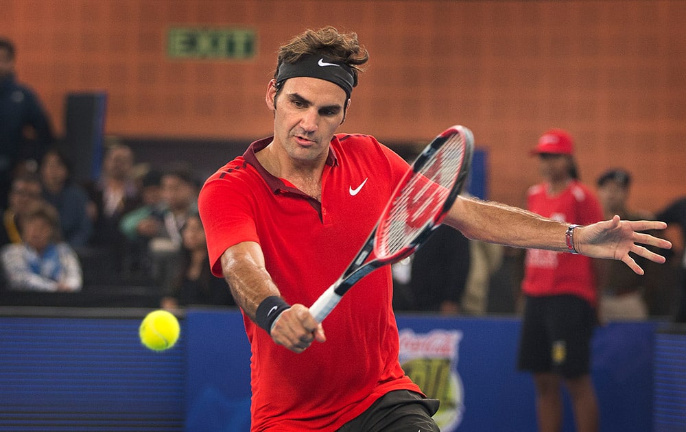 Micromax Indian Aces player Roger Federer returns a ball to Musafir.com UAE Royals Novak Djokovic during International Premier Tennis League, in New Delhi.