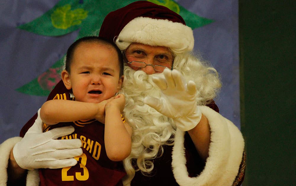 This photo shows a crying child unsure of what to make of Santa Claus in Shishmaref, Alaska. 