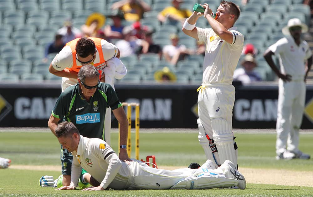 Australia's Michael Clarke stretches after injuring himself during the first day of a cricket test match against India in Adelaide, Australia.