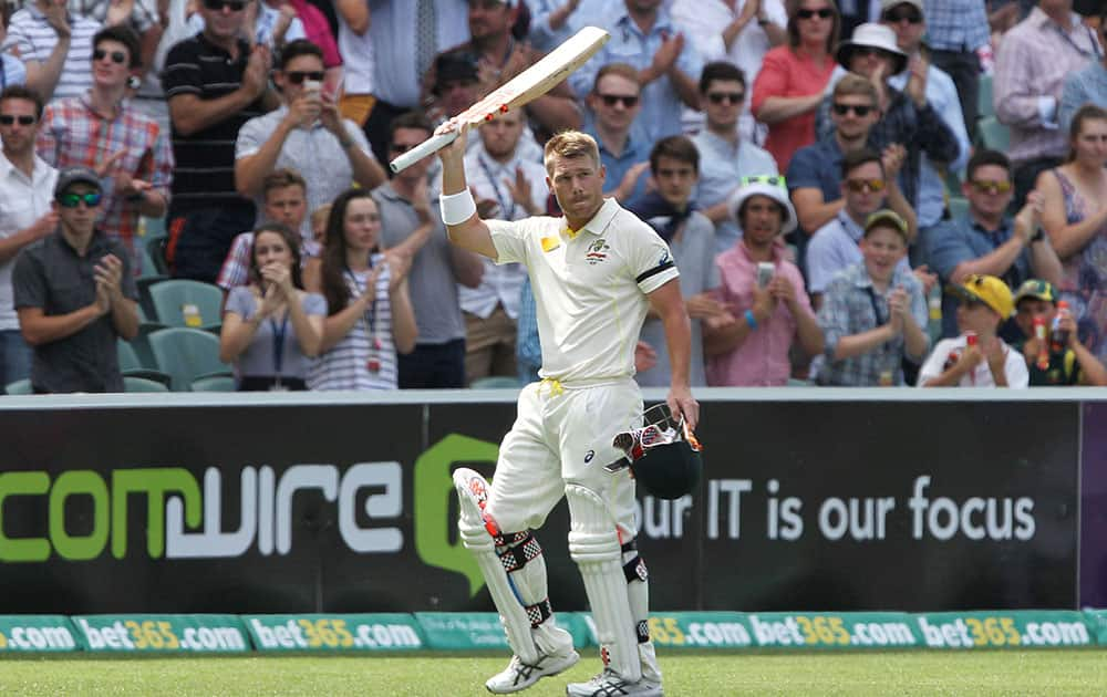 Australia's David Warner walks after losing his wicket during the first day of the cricket match against India in Adelaide, Australia.