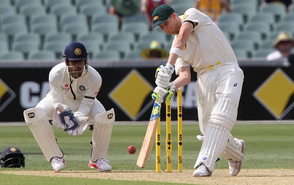 Australia's Steven Smith drives the ball during the first day of the cricket test match against India in Adelaide, Australia.