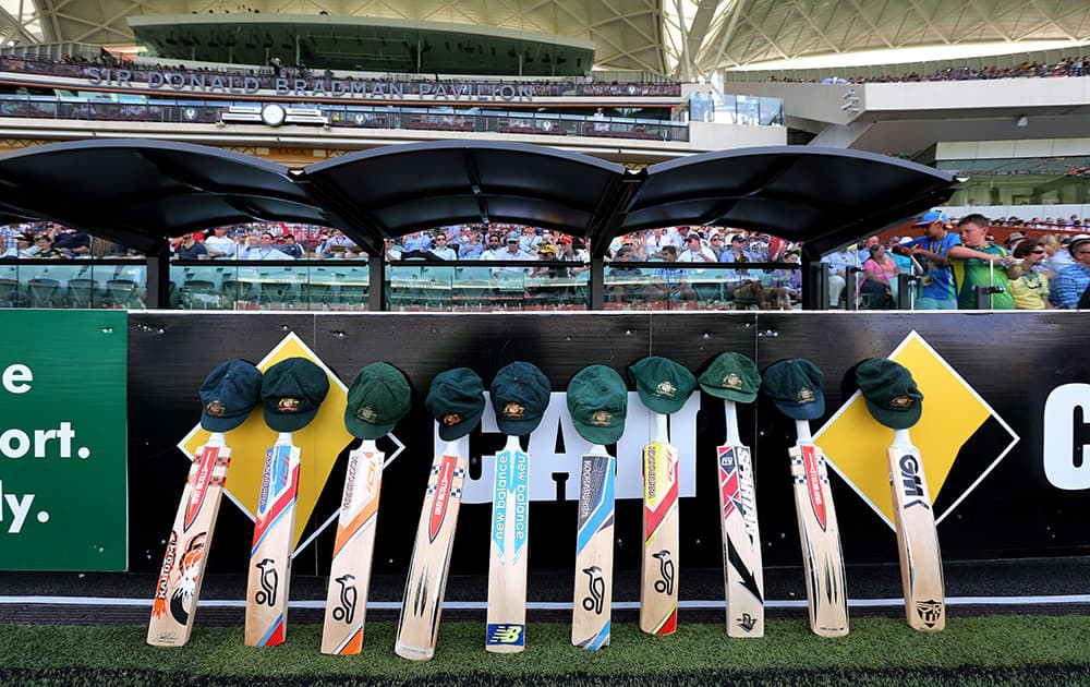 Bats line up in honor of late Australian cricket player Phil Hughes, during the first day of the cricket match between Australia and India in Adelaide, Australia.