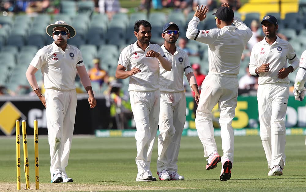 Mohammed Shami celebrates the wicket of Australia's Nathan Lyon, during the first day of the cricket match in Adelaide, Australia.