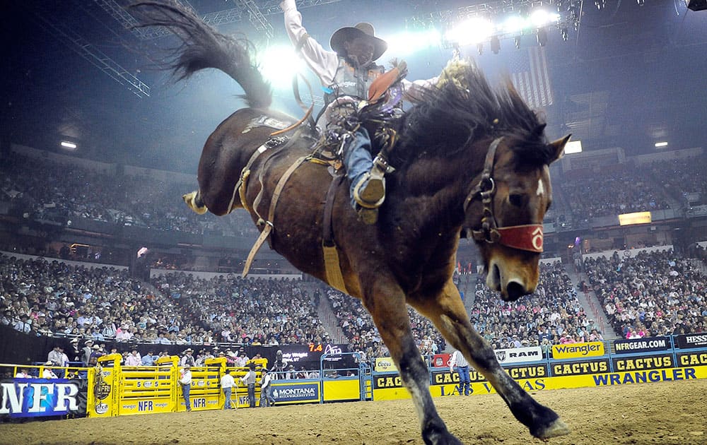 Cody Wright of Milford, Utah competes in the saddle bronc riding during the fifth go-round of the National Finals Rodeo at the Thomas & Mack Center in Las Vegas.