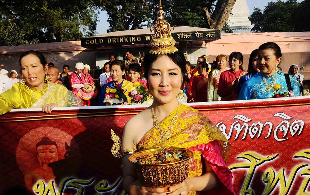 Devotees from Thailand take part in a procession at Mahabodhi temple in Bodhgaya on Tuesday for the long life of Thai king.