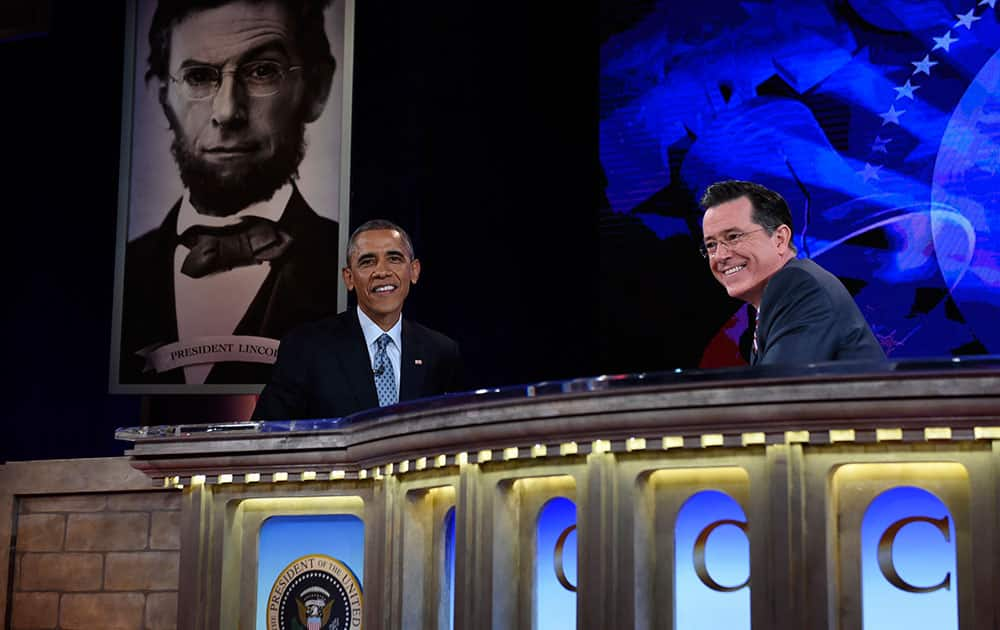 President Barack Obama talks with Stephen Colbert of The Colbert Report during a taping of The Colbert Report program in Lisner Auditorium at George Washington University in Washington.