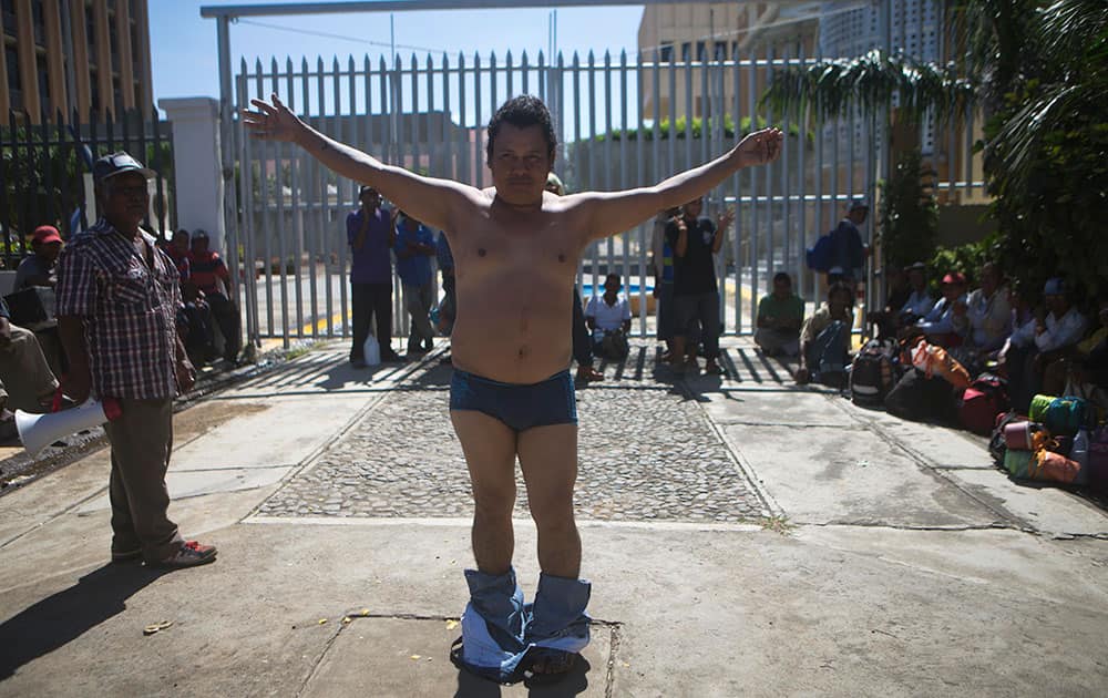 A former sugar cane worker and chronic renal failure patient, undresses during a protest in front of the National Assembly after a march from Chichigalpa to Managua, demanding compensation for damages to their health resulting from alleged exposure to agrochemicals and pesticides, in Managua, Nicaragua.