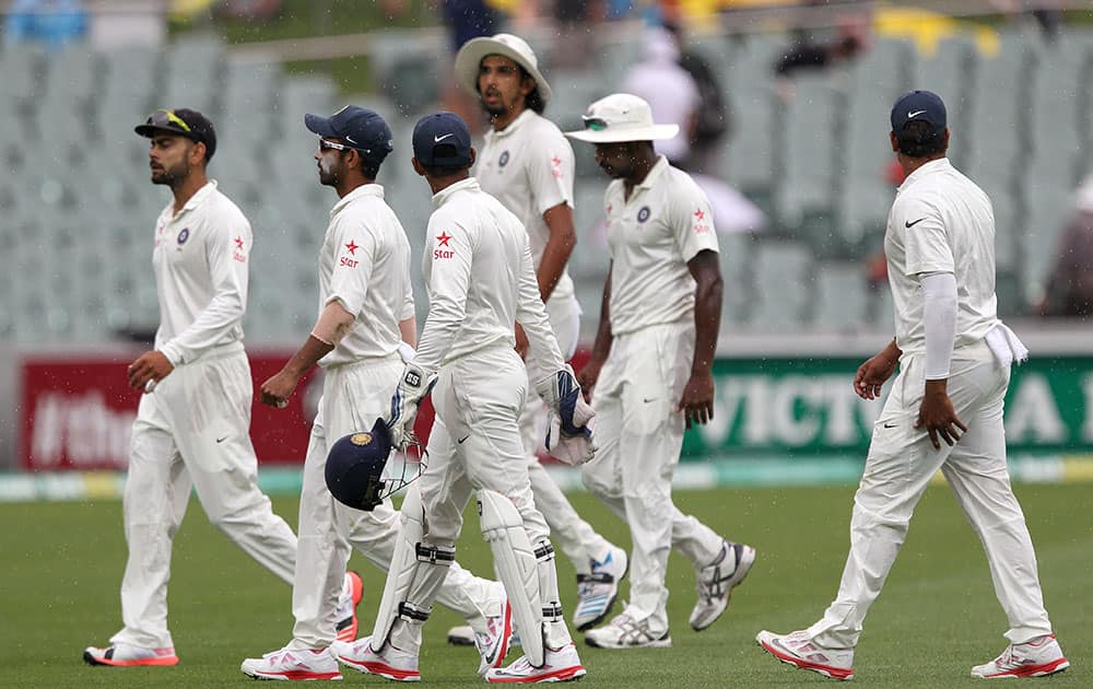 India players leave the field during a rain delay during the second day of their cricket test match against Australia in Adelaide, Australia.