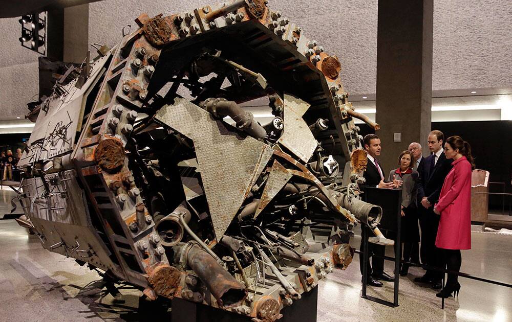 Kate, Duchess of Cambridge, and Britain's Prince William, with Joe Daniels, Joe Daniels , left, President & CEO of the National September 11 Memorial & Museum view the remains of the former broadcast tower from the World Trade Center, during their visit to the National September 11 Museum.