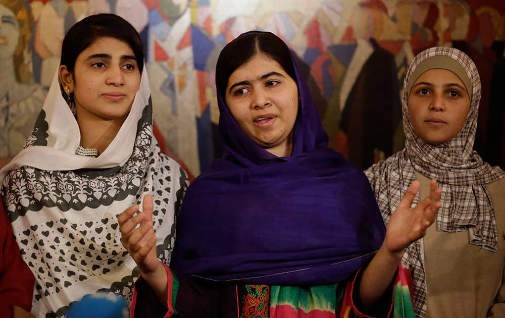 Joint-Nobel Peace prize winner Malala Yousafzai, center, stands with two of the five young women she invited to attend the Nobel Peace Prize ceremony, her school friend Shazia Ramzan, left, and Syria's Mezon Almellehan as they speak to the media at Malala's hotel in Oslo, Norway.