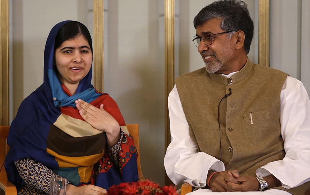 Joint-Nobel Peace prize winners Malala Yousafzai, left, and Kailash Satyarthi attend a press conference in Oslo, Norway.