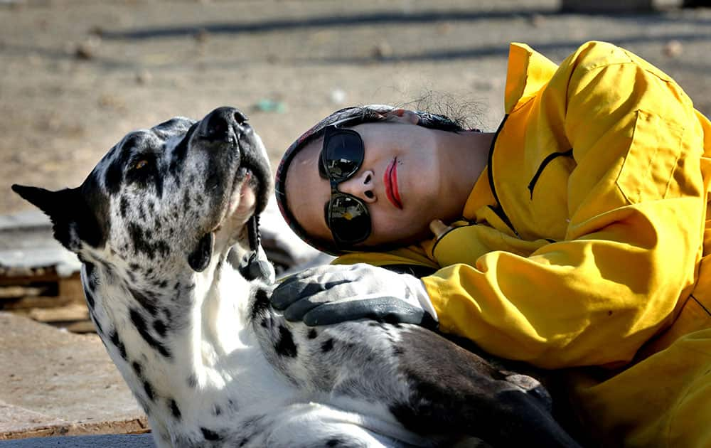 Homa Rashid, a lawyer and volunteer at the Vafa Animal Shelter, rests with a dog, in the city of Hashtgerd 43 miles (73 kilometers) west of the capital Tehran, Iran. More than 500 dogs find care and affection at the Vafa Animal Shelter, which was established through an endowment in 2004 and is the country’s only licensed animal refuge. 