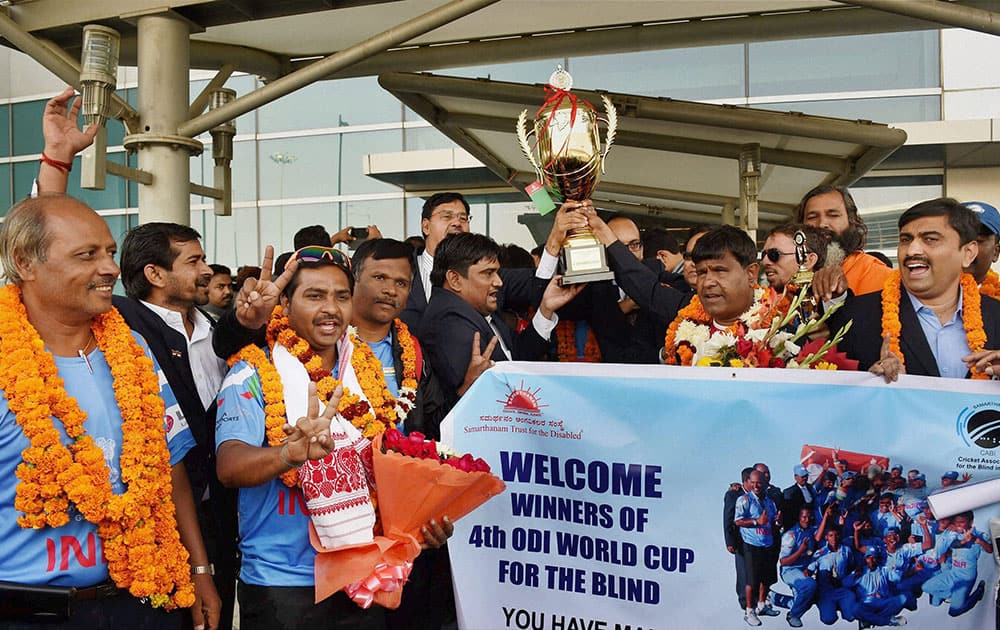 Indian blind cricket team being welcomed on their arrival at IGI airport after winning the Blind Cricket World Cup, in New Delhi.