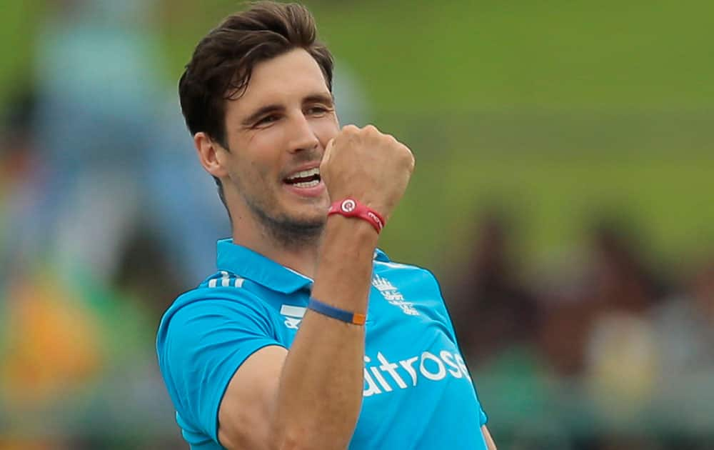 England's bowler Steven Finn celebrates the dismissal of Sri Lankan batsman Kusal Janith Perera during their fifth one day international cricket match in Pallekele , Sri Lanka.