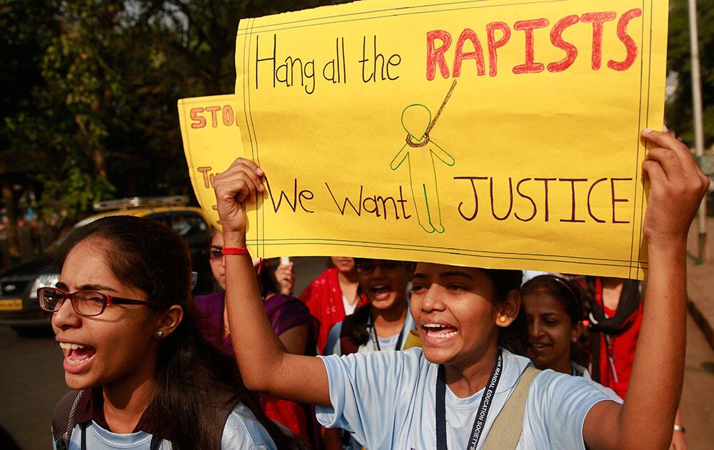 Indian students hold placards and shout slogans during a protest organized to create awareness on gender- based violence on women in Mumbai, India.