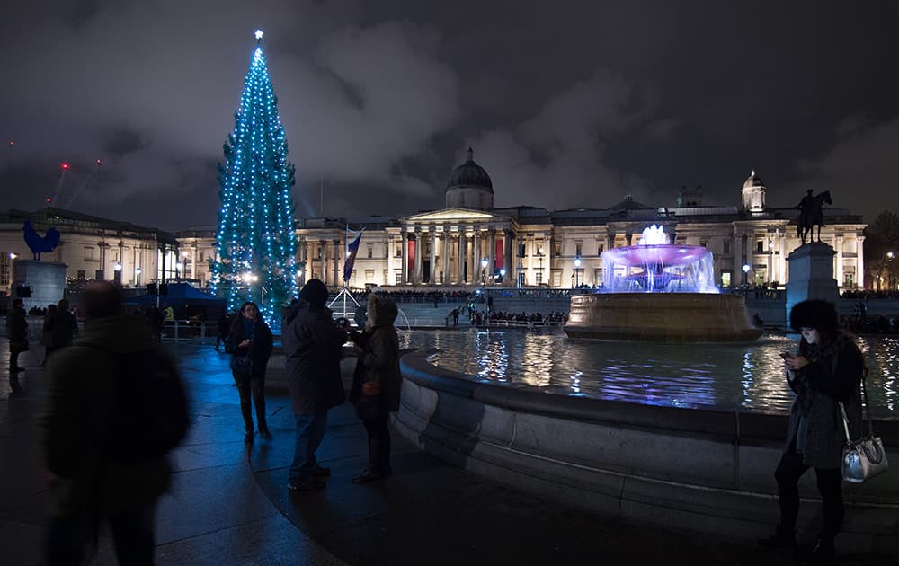 The Christmas tree shines in Trafalgar Square after the lighting ceremony in London.