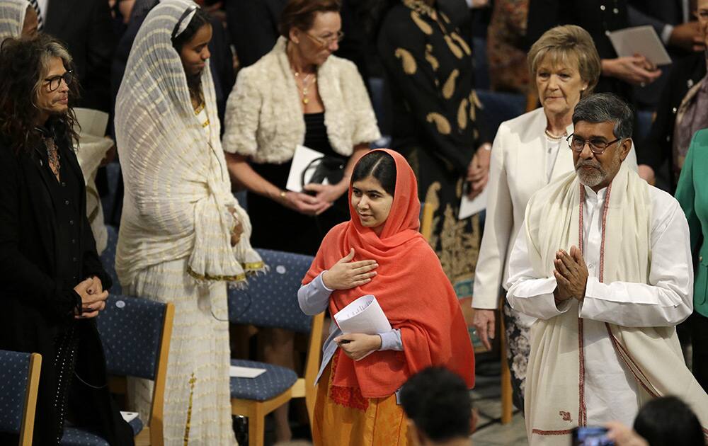 Rock star Steven Tyler, watches as Nobel Peace Prize winners Malala Yousafzai from Pakistan and Kailash Satyarthi of India arrive for the Nobel Peace Prize award ceremony in Oslo, Norway.