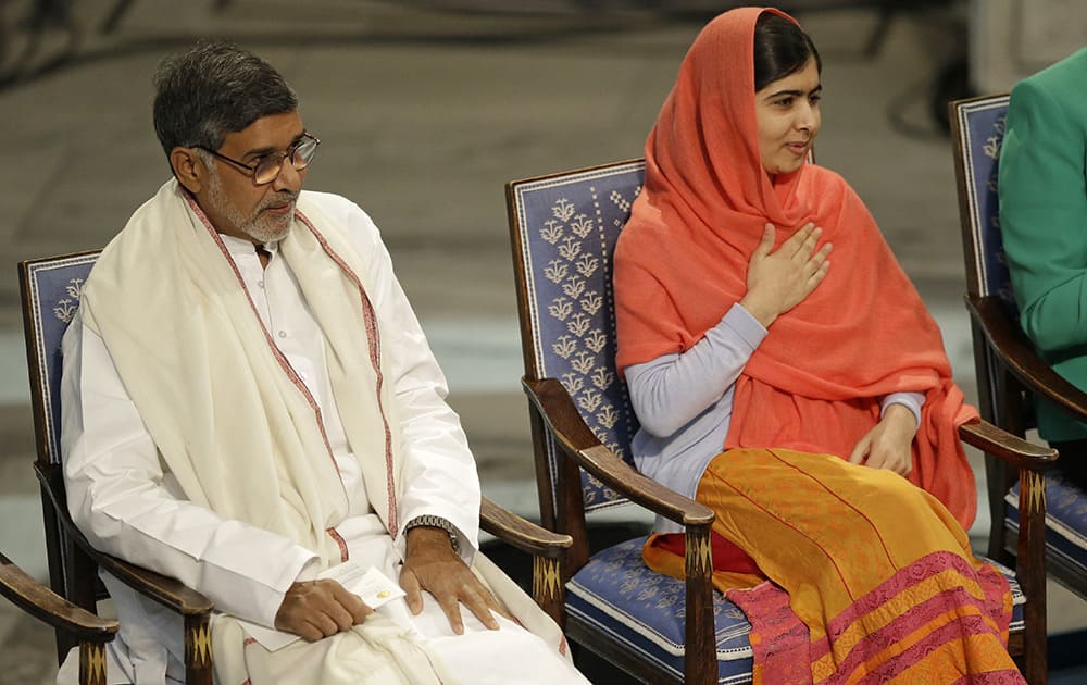 Nobel Peace Prize winners Malala Yousafzai from Pakistan, and Kailash Satyarthi of India take their seats during the Nobel Peace Prize award ceremony in Oslo, Norway.