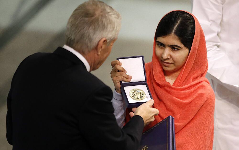 Nobel Peace Prize winner Malala Yousafzai from Pakistan receives her award from Chair of the Norwegian Nobel Committee, Thorbjorn Jagland during the Nobel Peace Prize award ceremony in Oslo, Norway.