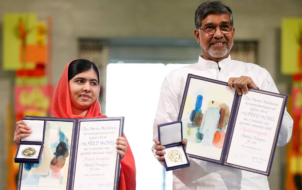 Nobel Peace Prize winners Malala Yousafzai from Pakistan and Kailash Satyarthi of India hold their Nobel Peace Prize diplomas and medals during the Nobel Peace Prize award ceremony in Oslo, Norway.