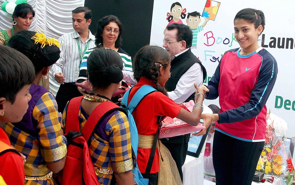 Ace Badminton player Ashwinin Ponnappa distributing books during the launch of Child Fund India Event Books my Friends in Bengaluru.