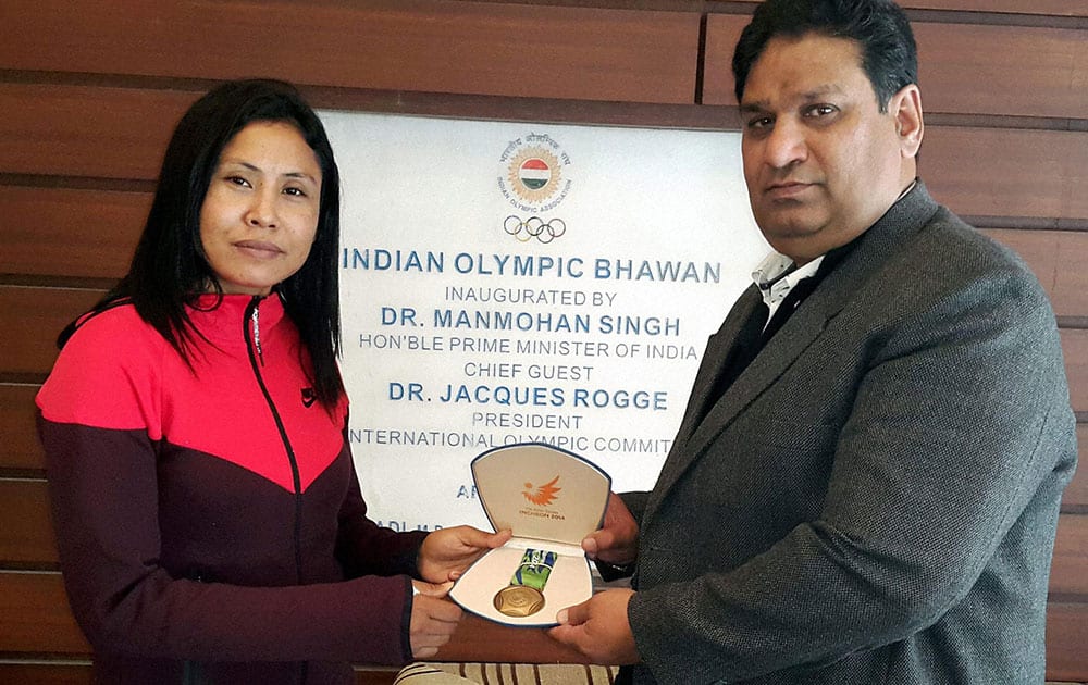 Indian boxer Sarita Devi received her Asian Games bronze medal from Indian Olympic Association, Secretary General, Rajeev Mehta, ( which she had refused to accept at the presentation ceremony ) in New Delhi.